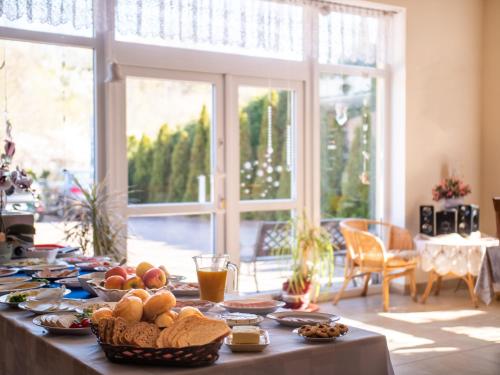 a table with food on it in a living room at Willa Bliska in Gdańsk