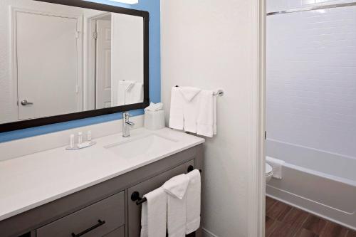 a bathroom with a sink and a mirror and a tub at Residence Inn Sunnyvale Silicon Valley I in Sunnyvale