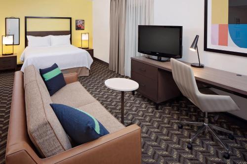 a hotel room with a bed and a couch and a tv at Residence Inn Sunnyvale Silicon Valley I in Sunnyvale