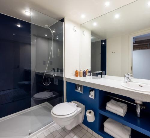 a bathroom with a toilet and a sink and a shower at Holiday Inn York City Centre, an IHG Hotel in York