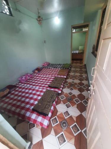 a room with a bed on the floor in a room at Bhaktikunj Detached 2 room House in Akalkot