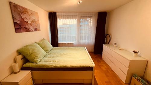 a small bedroom with a bed and a window at Messewohnung Düsseldorf/Essen in Ratingen