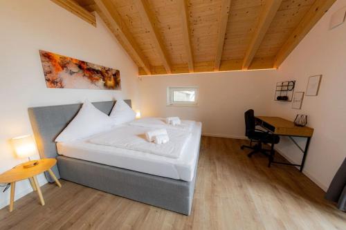 a bedroom with a bed and a desk in it at Servus Apartments Neuhaus am Inn in Neuhaus am Inn