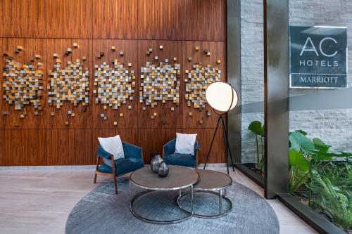 a lobby with two chairs and a table at AC Hotel by Marriott Monterrey Valle in Monterrey