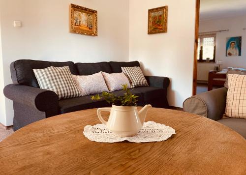 a living room with a table with a vase on it at Restauracja Pensjonat Buda in Krosno