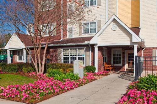 a house with pink flowers in front of it at TownePlace Suites New Orleans Metairie in Harahan