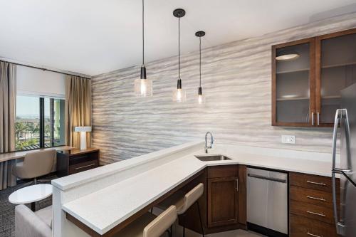 a kitchen with a sink and a counter top at Residence Inn Riverside Moreno Valley in Moreno Valley