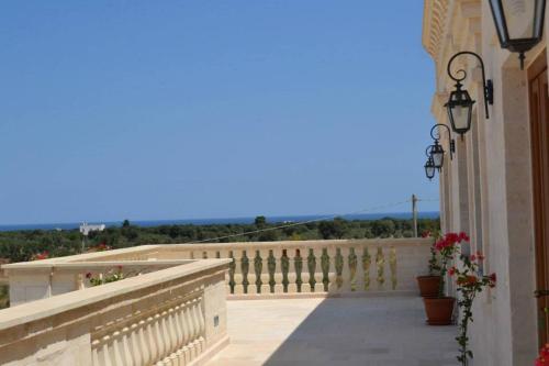 a balcony with a white fence and flowers on it at Agriturismo I Pozzetti in Savelletri di Fasano