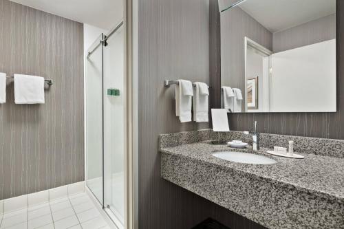 a bathroom with a sink and a shower at Courtyard by Marriott San Jose South/Morgan Hill in Morgan Hill
