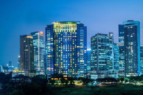 a city skyline at night with tall buildings at JW Marriott Hotel Jakarta in Jakarta