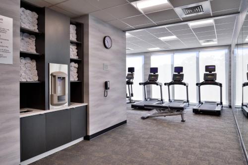 a gym with a row of exercise bikes and a clock at Fairfield Inn and Suites by Marriott Minneapolis Shakopee in Shakopee