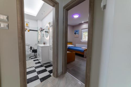 a room with a bathroom with a bed and a doorway at Seaside Serenity in Volos