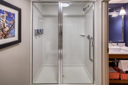 a shower with a glass door in a bathroom at Four Points by Sheraton Raleigh Durham Airport in Morrisville