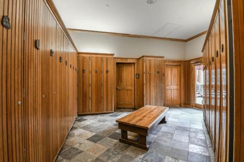 a room with wooden lockers and a wooden bench at Jack Pine 8015 in Keystone