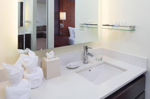 a white bathroom with a sink and a mirror at Residence Inn Minneapolis Downtown/City Center in Minneapolis