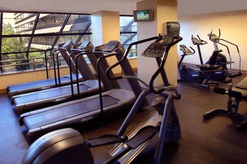 a gym with treadmills and elliptical machines at Boston Marriott Peabody in Peabody