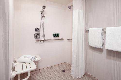 a white bathroom with a shower and a toilet at Courtyard San Jose Cupertino in Cupertino