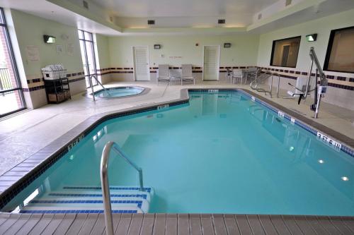 a large pool with blue water in a hotel room at SpringHill Suites Galveston Island in Galveston