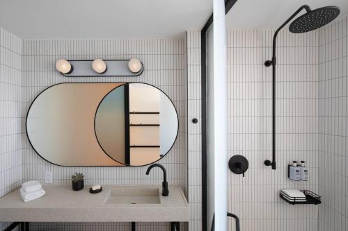 a bathroom with a sink and a mirror at Moxy Miami South Beach in Miami Beach