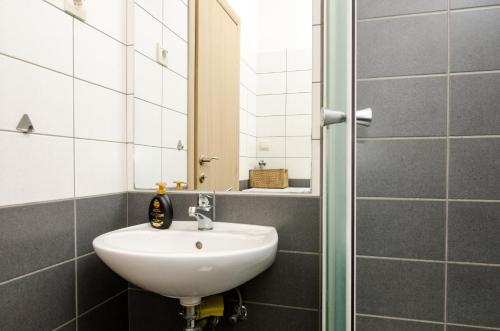 a bathroom with a sink and a mirror at Dubrovnik Summer Apartments in Dubrovnik