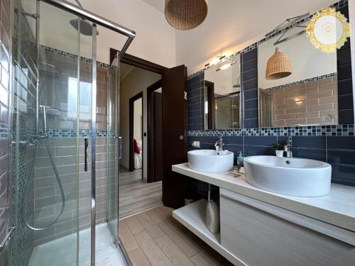 a bathroom with two sinks and a shower at Casa panoramica Roma SempiHome in Rome