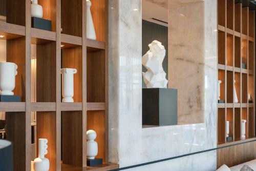 a museum with a statue in a glass case at AC Hotel by Marriott Scottsdale North in Scottsdale