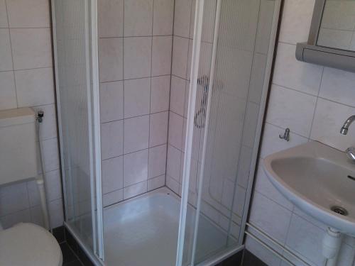 een badkamer met een douche, een toilet en een wastafel bij Stacaravanverhuur Kroon chalet B-10 in Workum