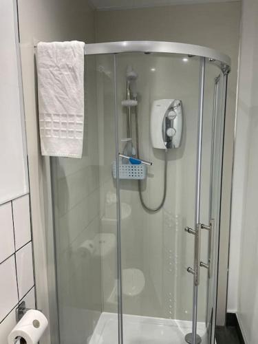 a shower with a glass door in a bathroom at 5 minutes from Loch Lomond - Recently Renovated in 2023 Ground Floor 1-Bed Flat in Bonhill