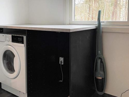 a counter with a washing machine next to a window at 6 person holiday home in HAKENÄSET-By Traum in Balkeröd