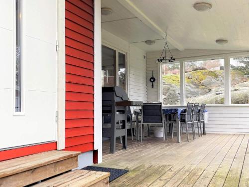 a porch with a table and chairs on a house at 6 person holiday home in HAKENÄSET-By Traum in Balkeröd
