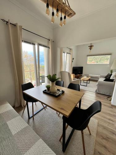 a living room with a wooden table and chairs at «Έλα…Δάρα» Home in Daras