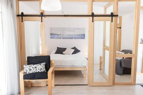 a bedroom with a bunk bed and a chair at Nowy dom przy starym krześle - w Pelniku in Pelnik
