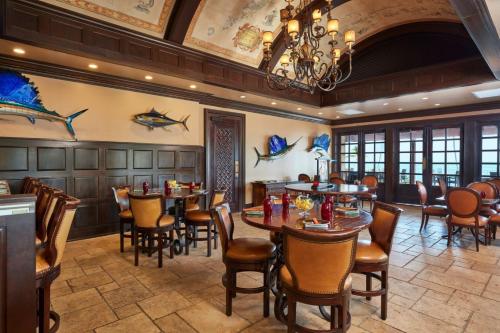 a restaurant with tables and chairs and a chandelier at Cheeca Lodge & Spa in Islamorada