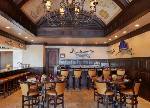 a restaurant with tables and chairs and a bar at Cheeca Lodge & Spa in Islamorada