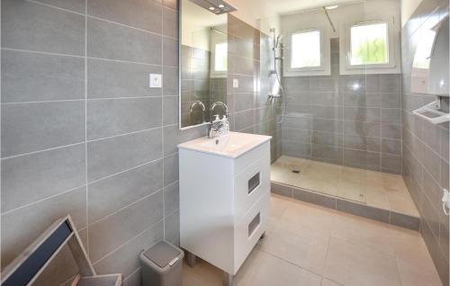 a bathroom with a white sink and a shower at 3 Bedroom Pet Friendly Home In Rognonas in Rognonas