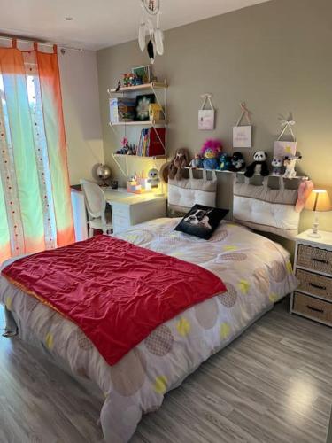 a bedroom with a large bed and a desk at Maison cadre paisible face au lac in Peigney