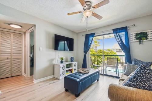 a living room with a couch and a ceiling fan at The Orchid by DNY Prime in Tampa
