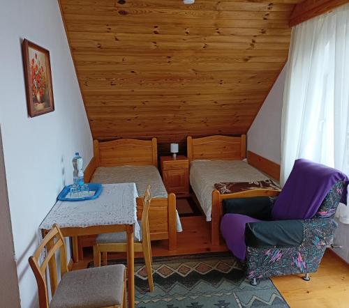 um quarto com uma cama, uma mesa e cadeiras em Podkamiencem em Odrzykoń