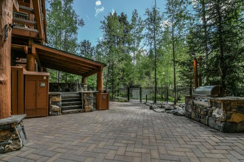 an outdoor patio with a grill and a building at Jack Pine 8016 in Keystone