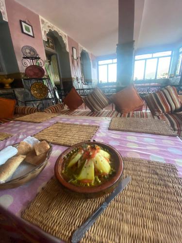 a room with a table with a plate of food on it at Tizintest LA HAUTE VUE 2100M - Hôtel Restaurant in Mezdiout
