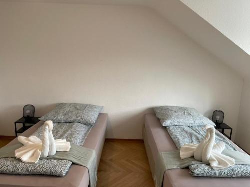 two beds in a room with swans on them at Comfortable Shared Apartment with Private Room in Wesseling in Wesseling