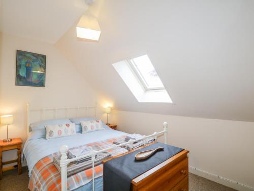 a bedroom with a bed and a skylight at The Old Mill in Beauly