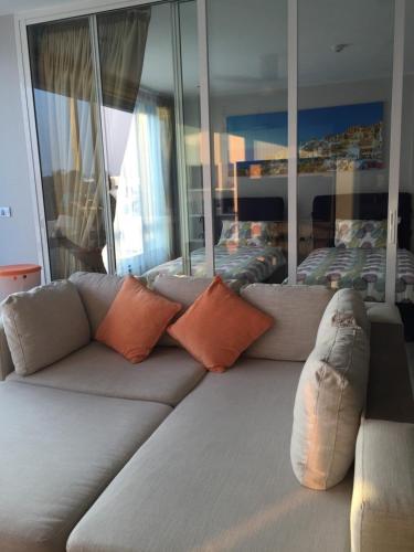 a living room with a couch and a bed at The Crest Santora Huahin 4 Fl H(Monthly rate) in Hua Hin