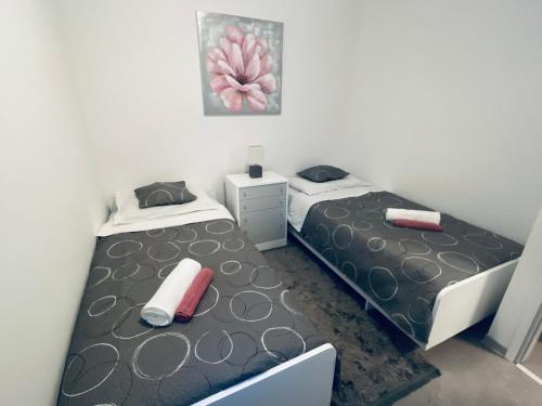 two beds in a small room with one bedskirts at Apartman Stipančić in Labin