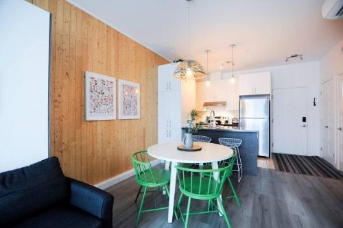 a kitchen and dining room with a table and chairs at La Réserve du Boisé - Parking, terrasse & Gym in Quebec City