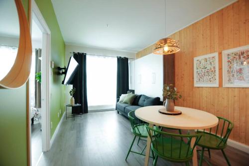 a living room with a table and a couch at La Réserve du Boisé - Parking, terrasse & Gym in Quebec City