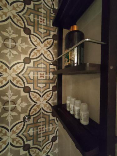 a bathroom with a shelf with candles on a wall at Dal Podestà in San Gemini