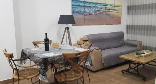 a living room with a table and a couch at apartamento la perla in Fuengirola