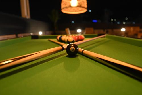 a cue ball on a pool table with apples on it at Puy Castele Hotel Tiberias in Tiberias