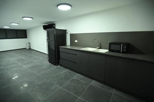 a kitchen with a sink and a refrigerator at Puy Castele Hotel Tiberias in Tiberias